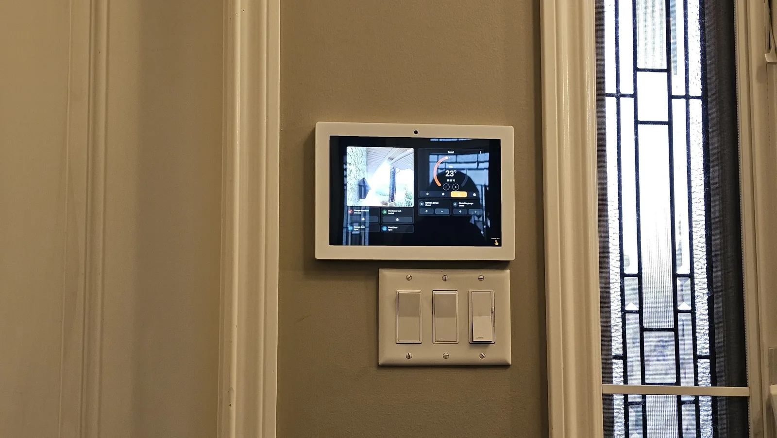 KeenAI wall-mounted lighting controls beside a smart panel, where the physical switches still operate normally